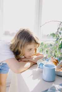 little girl staring at easter eggs